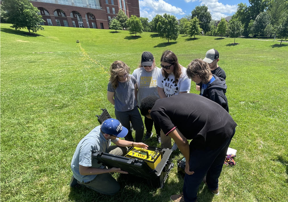 2024 Potter interns conducting a practice geophysical survey in front of the University of Kentucky library